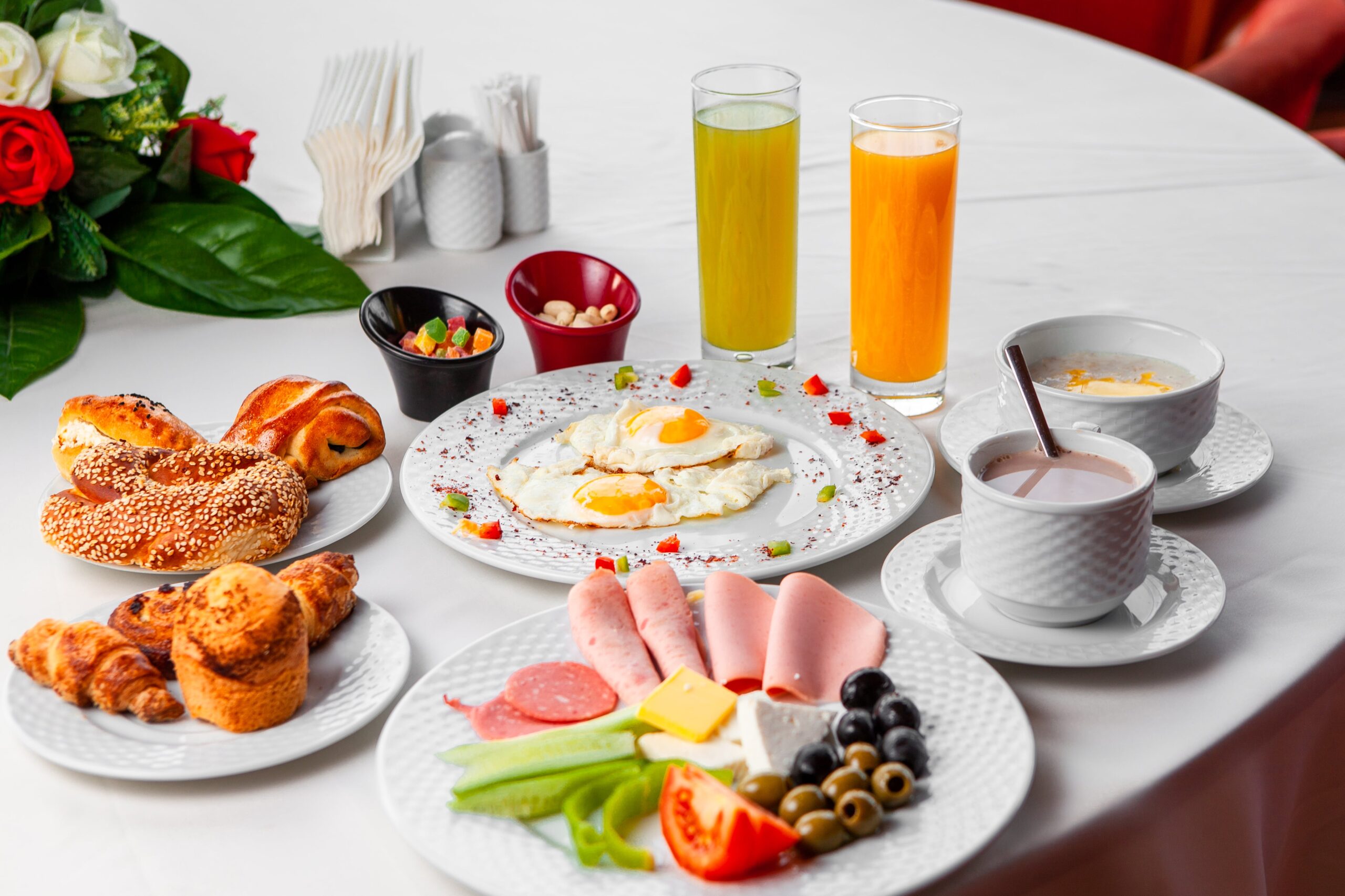 set-salad-fried-eggs-pastry-delicious-breakfast-table-white-background-high-angle-view-min