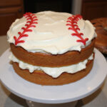 Finished baseball cake with buttercream frosting and baseball stitching design.