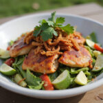 Delicious BBQ Chicken Ranch Salad garnished with cilantro and fried onions.