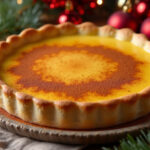 Finished Christmas Eve Cinnamon-Vanilla Creamy Custard Pie with cinnamon dusting, ready for holiday serving.