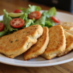Delicious and easy chicken bread recipe, sliced and served with salad.