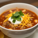 Finished Easy Chicken Taco Soup with toppings and tortilla chips.