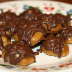 Finished Homemade Turtle Candy with caramel, pecans, and chocolate drizzle.