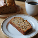Delicious slice of homemade high-altitude banana bread with coffee.