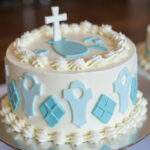 Perfect Baptism cake with white frosting and blue decorations.