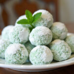 Finished Minty Snowball Cookies dusted with powdered sugar, perfect for holiday treats.