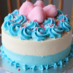 Finished Cotton Candy Cake with blue frosting, cotton candy, and sprinkles.