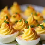 Finished Quick Deviled Eggs garnished with paprika and chives, perfect for appetizers.