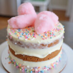 Finished Cotton Candy Cake with sprinkles and cotton candy decoration.