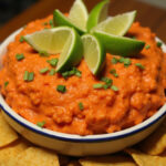Finished Zesty Cowboy Caviar Dip with tortilla chips, perfect for gatherings.