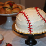 Finished baseball cake with frosting and stitching details, perfect for a baseball themed party.