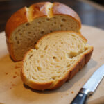 Freshly baked batard bread loaf with a perfect crumb.