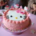 Finished Hello Kitty cake with pink frosting and sprinkles, perfect for a Hello Kitty themed party.