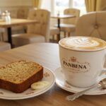 Perfectly served Banana Bread Latte in a café with banana bread slice, ideal for brunch enthusiasts.