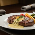 Final presentation of Juicy Steak with Creamy Garlic Sauce, a mouth-watering gourmet dish ready to be served.