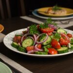 Finished dish of marinated cucumbers, onions, and tomatoes garnished and ready to be served.