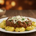 Final presentation of Philly Cheesesteak Tortellini Pasta, featuring tortellini, steak, sautéed vegetables, and melted cheese, perfect for a hearty meal.
