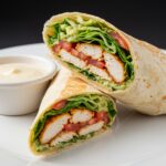 Savory chicken wraps with garlic cream sauce, beautifully presented for a delightful meal.