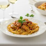 Elegant display of spicy Cajun honey butter chicken and pasta, showcasing a delicious and inviting meal setting.