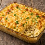 Deliciously baked Three-Cheese Baked Macaroni, golden and cheesy crust, comforting pasta dish presentation on a rustic wooden table.