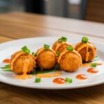 Final presentation of crispy Bang Bang salmon bites, expertly garnished and plated for an appetizing look.