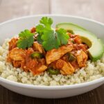 Delicious Healthy Chicken Enchilada Bowl with cauliflower rice and chicken, vibrant presentation, healthy meal ideas on wooden table.